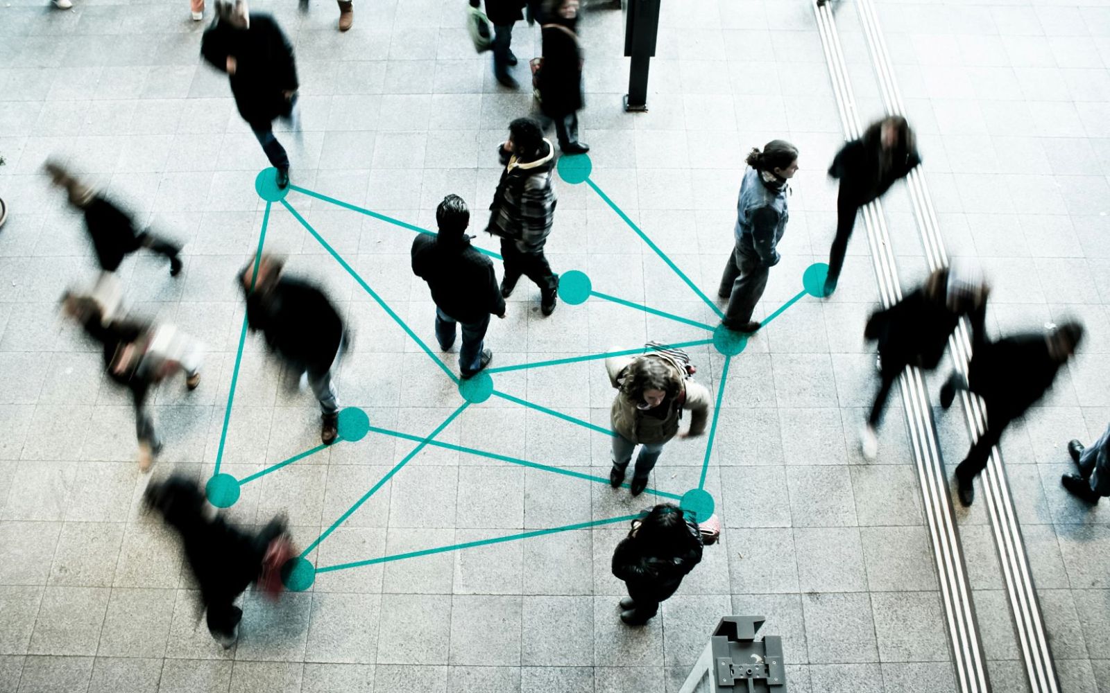 Top-down perspective of people walking with some connected by teal lines and dots.